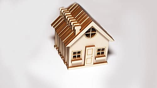 Small wooden house model on a white background