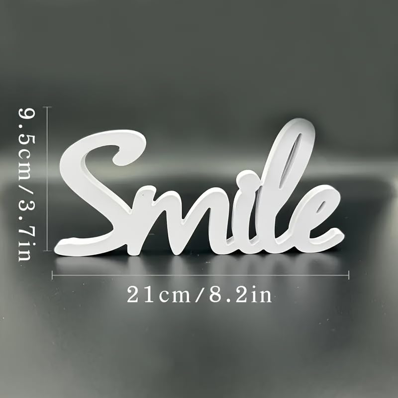 White decorative sign with 'Smile' text and measurements on a dark background