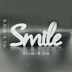 White decorative sign with 'Smile' text and measurements on a dark background