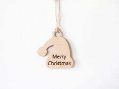 Wooden Christmas ornament shaped like a Santa hat with 'Merry Christmas' text on a white background