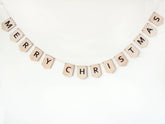 Merry Christmas banner made of wooden letters on a white background