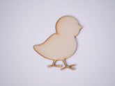 Wooden chick shape on a light gray background