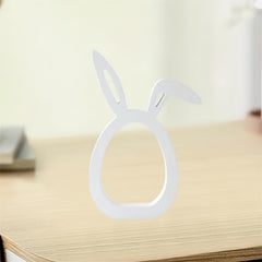 Clear plastic bunny ear stand on a wooden surface