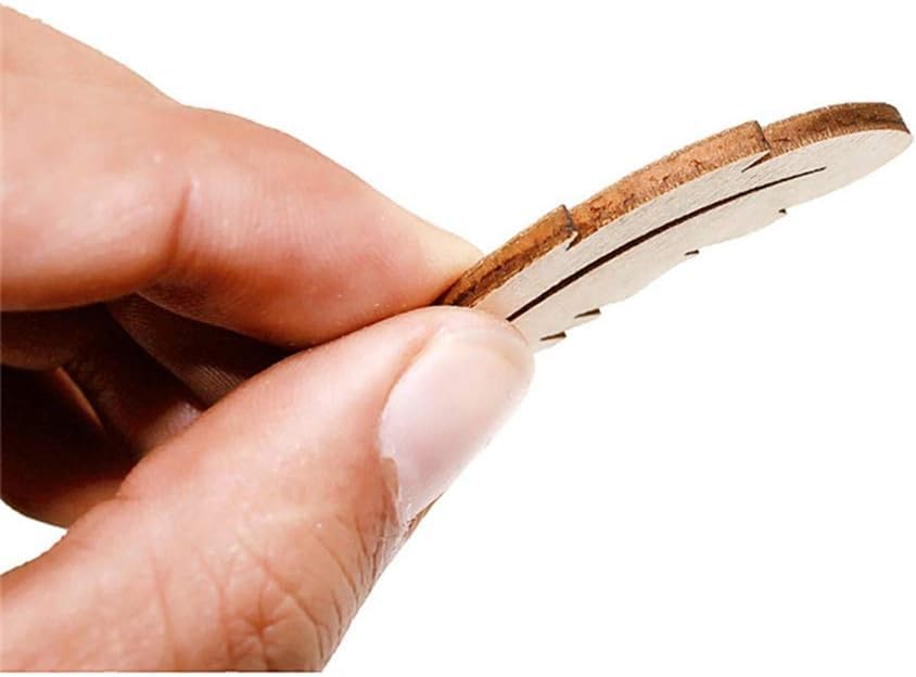 Hand holding a small cork product against a white background