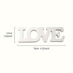 White wooden letters spelling 'LOVE' with measurements on a white background
