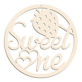 Wooden decorative cutout with 'Sweet One' and a pineapple design on a white background