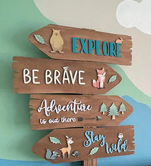 Wooden sign with motivational phrases and animal illustrations on a colorful background