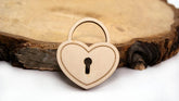 Wooden heart-shaped lock on a wooden surface