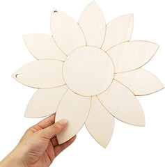 Hand holding a white flower-shaped cutout against a white background