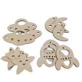 Set of wooden cutouts shaped like a fish, moon, star, and shell on a white background.
