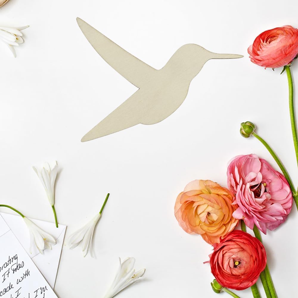 Decorative paper hummingbird with pink and orange flowers on a white background