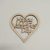 Wooden heart-shaped sign with 'Happy Valentine's Day' text on a light gray background