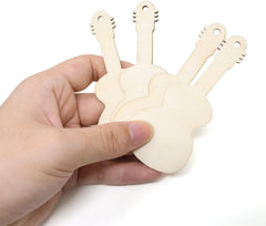 Hand holding a set of wooden guitar-shaped tools on a white background