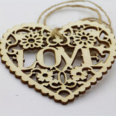 Wooden heart-shaped ornament with 'LOVE' engraving on a white background