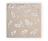 Decorative stencil with holly leaf patterns on a beige background