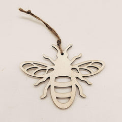 Wooden bee ornament hanging on a string against a light background
