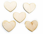 Five heart-shaped wooden cutouts on a white background