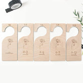 Set of wooden baby size dividers with engraved measurements on a white background.