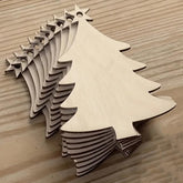 Wooden Christmas tree and star decorations on a wooden surface