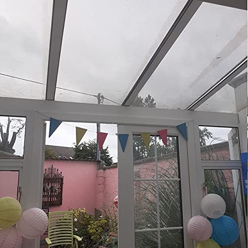 Clear glass conservatory with colorful bunting and decorative lanterns.