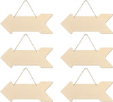 Set of six wooden arrow-shaped signs with hanging strings on a white background