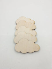 Set of cloud-shaped wooden cutouts on a white background