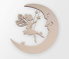 Wooden cutout of a fairy on a moon with stars on a white background