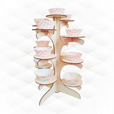 Wooden cupcake stand with colorful cupcake liners on a white background