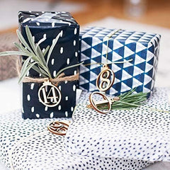 Two wrapped gifts with decorative ribbons and numbers on a patterned surface