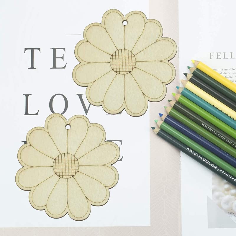Two flower-shaped cutouts on a piece of paper with colored pencils on a white background.