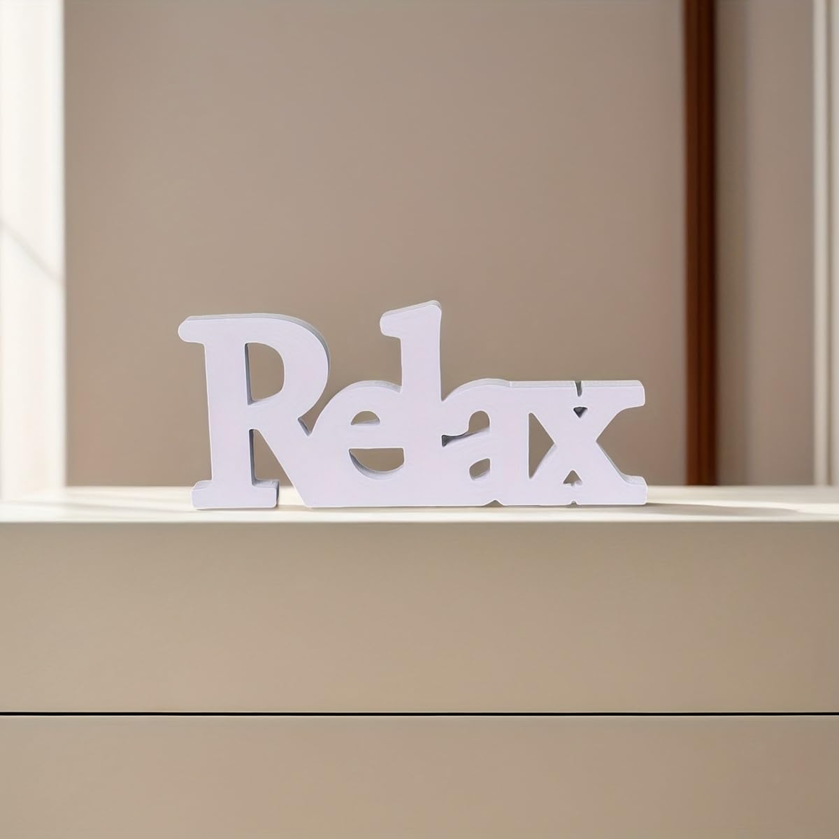 White 'Relax' sign on a beige surface