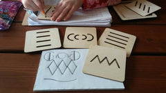 Wooden educational cards with symbols on a wooden surface