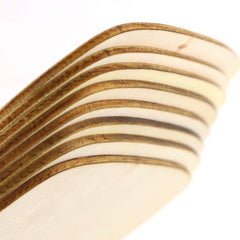 Close-up of a wooden spoon with layered design on a white background