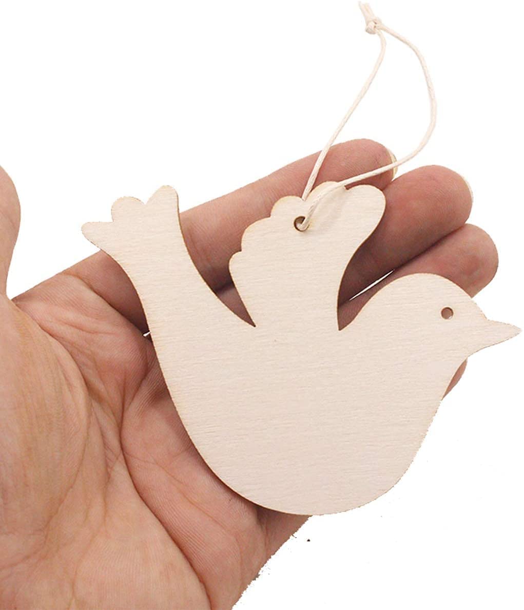 Wooden dove ornament held in a hand against a white background