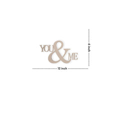Decorative wooden cutout with 'YOU & ME' text and measurements on a white background