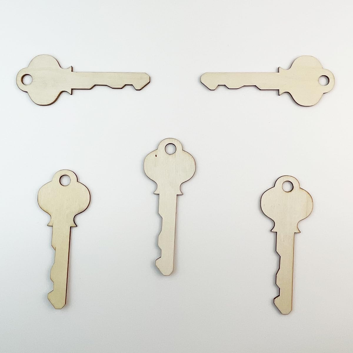 Five wooden key-shaped objects on a light gray background