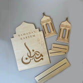 Wooden Ramadan decorations including lanterns and a card with 'Ramadan Kareem' on a gray background