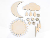 Set of wooden weather-themed shapes including sun, moon, cloud, raindrops, snowflakes, and lightning bolt on a white background.