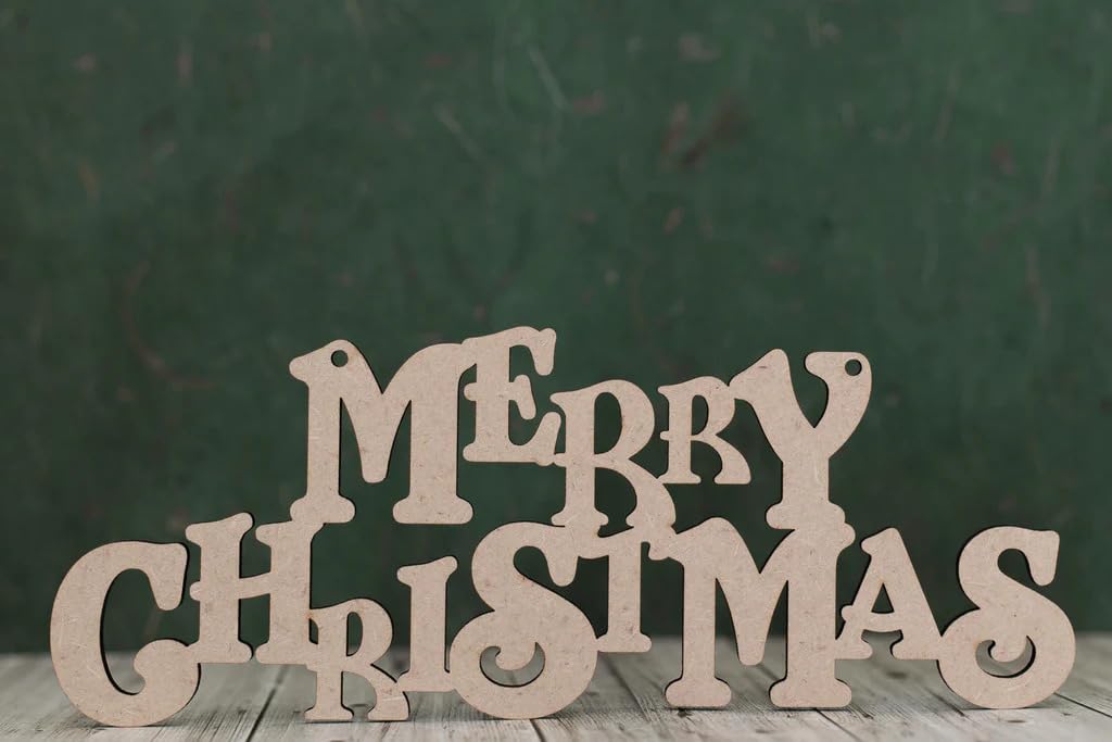 Wooden 'Merry Christmas' letters on a wooden surface with a dark green background