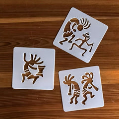 Three square stencils with tribal designs on a wooden surface