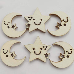 Wooden moon and star decorations with smiling faces on a light gray background