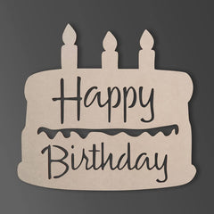 Cardboard cutout of a birthday cake with 'Happy Birthday' text on a dark background