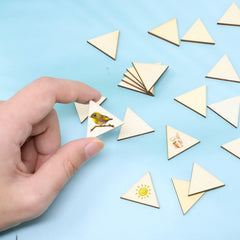 Hand placing a triangle-shaped wooden card with a bird illustration on a blue background.