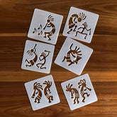 Set of six square stencils with Kokopelli designs on a wooden surface