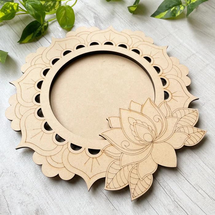 Wooden circular decorative item with lotus design on a light wooden surface.