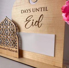 Wooden countdown to Eid holder with decorative elements on a neutral background