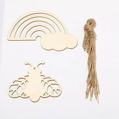 Wooden rainbow, cloud, and butterfly shapes with twine on a white background