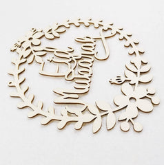 Wooden wreath cutout with floral and deer design on a white background