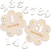 Wooden baby milestone cards with flowers and numbers on a white background