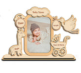 Wooden photo frame with baby milestone details on a white background